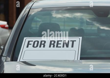 Close-up of car with placard on it is for rent Stock Photo