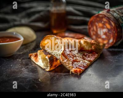 Pizza on a table with ingredients Stock Photo