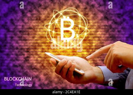 Blockchain technology concept, Businessman holding smartphone and virtual system diagram bitcoin. Stock Photo