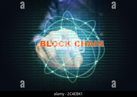 Asian young man pointing virtual screen blockchain connection and binary code on screen. Stock Photo