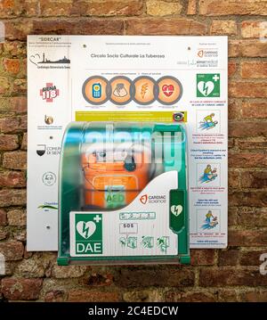 Cardiac defibrillator on a building wall in Siena. Italy. Stock Photo
