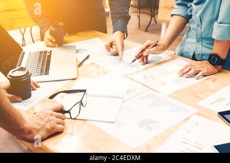 Brainstorming team of asian startup coworkers doing work on desk at home office. Stock Photo