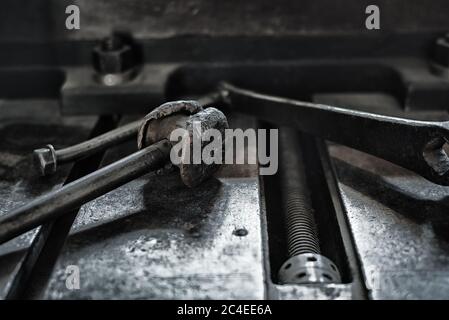 Vintage old metallic tools laying on a iron table surface Stock Photo