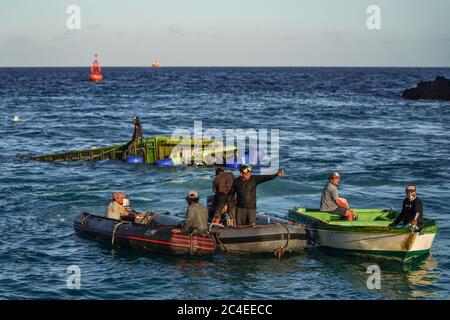 Karangasem, Bali, Indonesia. 26th June, 2020. Small boats drags a floated truck to the nearest possibly point to the crane. Passenger Ferry (KMP) Dharma Rucitra III from Lombok island that capsized on June 13 at Padang Bai Harbour, Bali, still on evacuation attempt. Credit: Dicky Bisinglasi/ZUMA Wire/Ģ����ý Live News Stock Photo