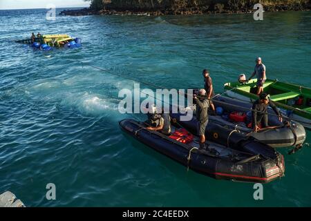 Karangasem, Bali, Indonesia. 26th June, 2020. Small boats drags a floated truck to the nearest possibly point to the crane. Passenger Ferry (KMP) Dharma Rucitra III from Lombok island that capsized on June 13 at Padang Bai Harbour, Bali, still on evacuation attempt. Credit: Dicky Bisinglasi/ZUMA Wire/Ģ����ý Live News Stock Photo