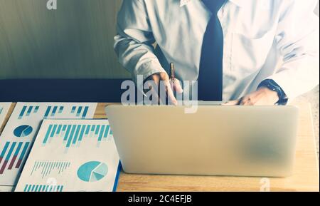 Businessman working in office room and using laptop computer. Stock Photo
