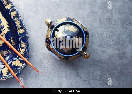 Two Chopsticks on empty plate on black background. Stock Photo