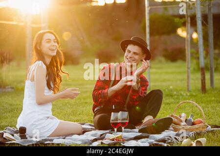 Laughting. Caucasian young couple enjoying weekend together in the park on summer day. Look lovely, happy, cheerful. Concept of love, relationship, wellness, lifestyle. Sincere emotions. Stock Photo