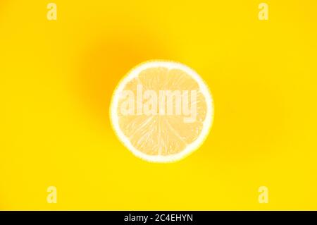 Top view of Sliced lemon on isolated yellow background Stock Photo