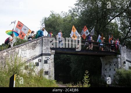 Denham, UK. 26 June, 2020. Activists from HS2 Rebellion and Extinction Rebellion UK take part in a ‘Rebel Trail’ hike along the route of the HS2 high-speed rail link from Birmingham to London. The activists, who departed from Birmingham on 20th June and will arrive outside Parliament in London on 27th June, are protesting against the environmental impact of the high-speed rail link and questioning the viability of the £100bn+ project. Credit: Mark Kerrison/Alamy Live News Stock Photo