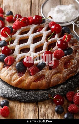 berry pie mix with raspberries, blueberries and cherries close-up on a slate board on the table. vertical Stock Photo