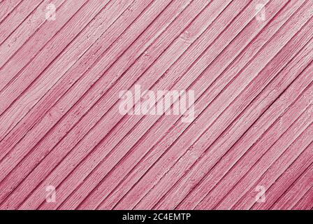 pink abstract background of diagonally arranged old wooden planks with cracked paint texture Stock Photo