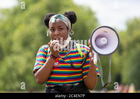 A young black girl addresses a crowd with a megaphone during a Black Lives Matter demonstration, Hyde Park, London, 20 June 2020 Stock Photo