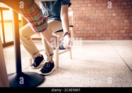 Two school hand passing notes to each other secretly during class. Stock Photo