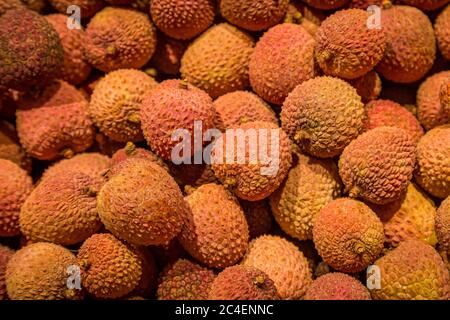 An abundance of lychees for sale on a market stall Stock Photo