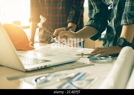 Two architects working together on project and using laptop checking data about construction. Stock Photo