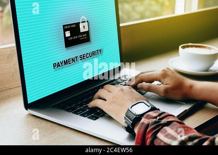 Secure payment concept with man hand using laptop at cafe coffee shop. Stock Photo