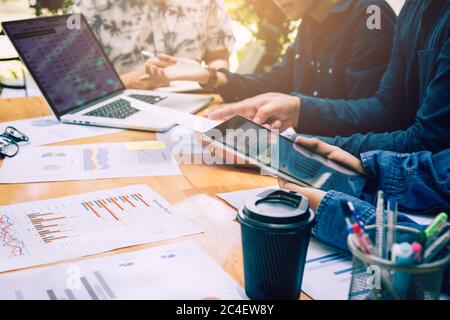 Asian colleagues using tablet and analysis about financial result working together. Stock Photo