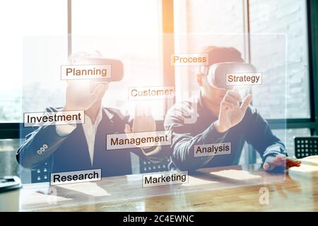 Business people are using VR technology presentation in boardroom. Stock Photo
