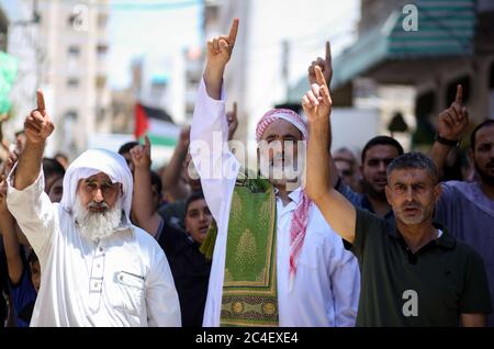 Palestinian Hamas supporters chant slogans during a protest against Israel's plan to annex parts of the occupied West Bank in the southern Gaza Strip. Stock Photo