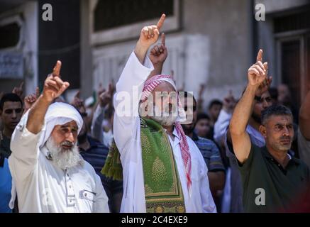 Palestinian Hamas supporters chant slogans during a protest against Israel's plan to annex parts of the occupied West Bank in the southern Gaza Strip. Stock Photo