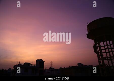 Beawar, Rajasthan, India, June 26, 2020: Sky over buildings wears different colors during sunset in Beawar. The monsoon arrived in Rajasthan with rains lashing some parts of the state. Credit: Sumit Saraswat/Alamy Live News Stock Photo