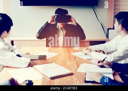 Asian business meeting with manager using virtual reality technolody headset. Stock Photo