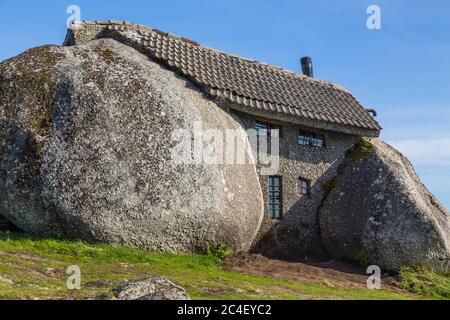 Casa do Penedo, a house built between huge rocks on top of a mountain in Fafe, Portugal. Commonly considered one of the strangest houses in the world. Stock Photo