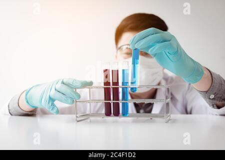 Young asian man medical researcher looking test tubes glass in laboratory. Stock Photo