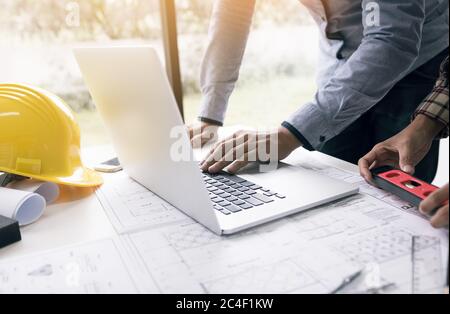 Architect discussing new project and using laptop with colleague in office. Stock Photo