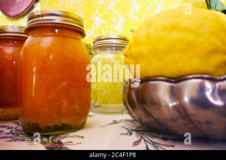jars of orange marmalade and a giant yellow cedar on a steel jug in a kitchen Stock Photo