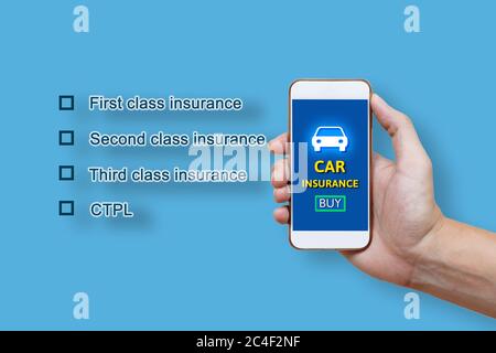 Car insurance concept and man hand holding smartphone. Stock Photo