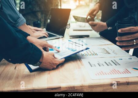 Teamwork with business people analysis cost graph on desk at meeting room. Stock Photo