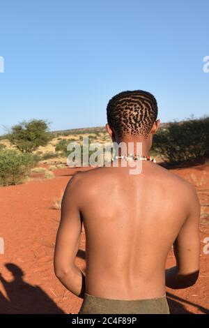 KALAHARI, NAMIBIA - JAN 24, 2016: Bushman hunter in the Kalahari desert. San people, also known as Bushmen are members of various Stock Photo