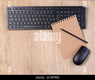 office table with  computer keyboard, mouse, cup of coffee,  and copy space Stock Photo