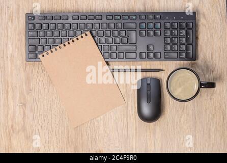 office table with  computer keyboard, mouse, cup of coffee, copy space Stock Photo
