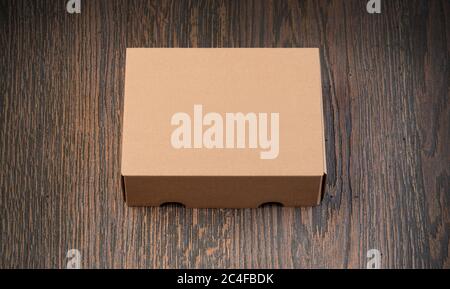 Empty brown carton box on the wooden table Stock Photo