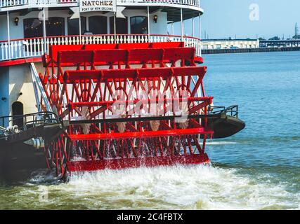 Paddlewheel, Natchez Steamboat Riverboat Flags Wharf Mississippi River New Orleans Louisiana.  One of the last Sternwheel Steamboats on the River and Stock Photo