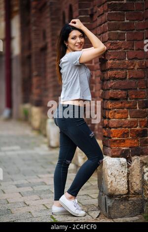 girl in a gray T-shirt smiling in the city Stock Photo