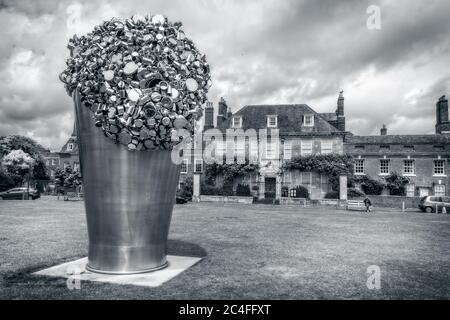 Stainless steel When Soak Becomes Spill Sculpture by Subodh Gupta in Choristers Square near   Salisbury Cathedral, Salisbury, Wiltshire, UK on 19 June Stock Photo