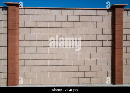 White grey brick wall concrete texture with orange columns. Grunge, cement. Seamless texture of a brick wall Stock Photo