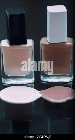 Nail polish bottles with reflection on a dark background. Stock Photo
