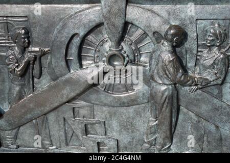 Women working in the manufacturing of aircrafts. Bronze bas-relief located on the World War II Memorial, Washington, DC, USA. Stock Photo