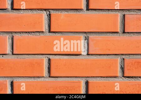 A close up of a brick building. background section of brick wall orange macro. part of brick wall. Stock Photo