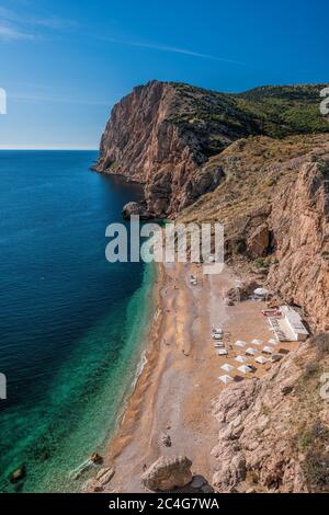 Beautiful Vasili beach in Balaklava, Sevastopol, Russia. View from the top of the rock. azure sea, sunny day clear sky background. Copy space. The Stock Photo