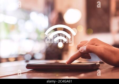 Wifi sign icon and connection screen of smartphone with top view city background. Financial business technology freedom dream life using internet free Stock Photo