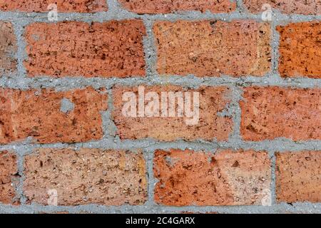 Weathered stained old red brick wall background. Stock Photo