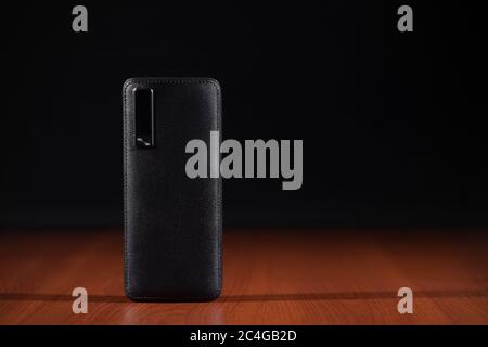 black power bank for charging mobile devices on black background Stock Photo