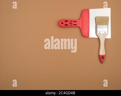 Construction tools on a beige background. Brush and spatula. Stock Photo