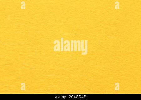 High resolution close up of bright yellow felt fabric texture of rough fleecy fabric of yellow color for backgrounds and for wallpaper an intense Stock Photo